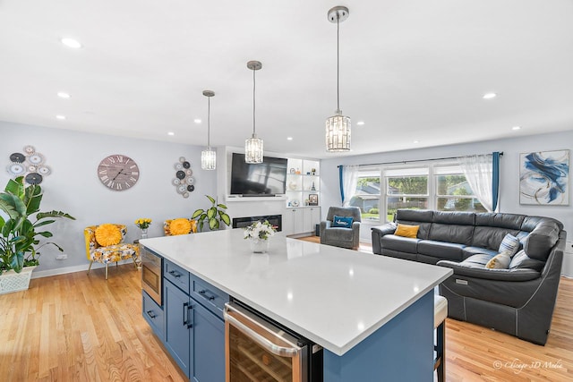 384 Glen Farm Ln, Lake Zurich, IL 60047 - kitchen featuring wine cooler, stainless steel microwave, open floor plan, blue cabinetry, and light countertops