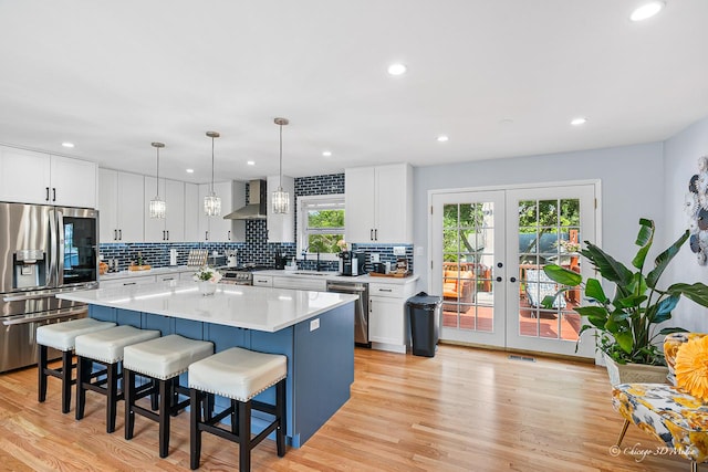 384 Glen Farm Ln, Lake Zurich, IL 60047 - kitchen featuring stainless steel appliances, french doors, backsplash, a kitchen breakfast bar, and white cabinetry