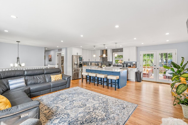 384 Glen Farm Ln, Lake Zurich, IL 60047 - living area with healthy amount of natural light, recessed lighting, light wood-style floors, a chandelier, and french doors