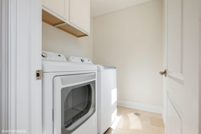 803 Pine St, Deerfield, IL 60015 - laundry area featuring separate washer and dryer, cabinet space, light tile patterned floors, and baseboards