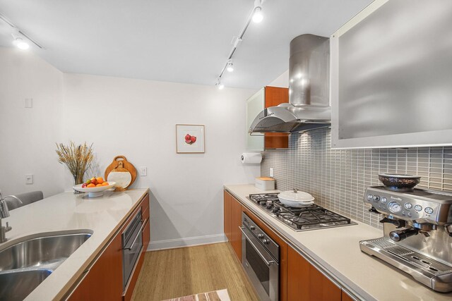 340 E Randolph St Unit 1304, Chicago, IL 60601 - kitchen with stainless steel appliances, island range hood, rail lighting, light wood-style flooring, and a sink