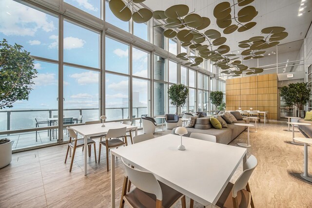 340 E Randolph St Unit 1304, Chicago, IL 60601 - dining area featuring a towering ceiling, a wall of windows, and plenty of natural light