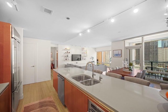 340 E Randolph St Unit 1304, Chicago, IL 60601 - kitchen featuring a sink, open floor plan, appliances with stainless steel finishes, light wood-style floors, and light countertops