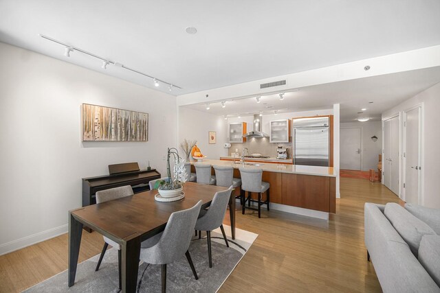 340 E Randolph St Unit 1304, Chicago, IL 60601 - dining space featuring rail lighting, light wood finished floors, and baseboards