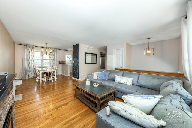 25 Olympus Dr, Naperville, IL 60540 - living room featuring a chandelier, light wood-style flooring, and baseboards