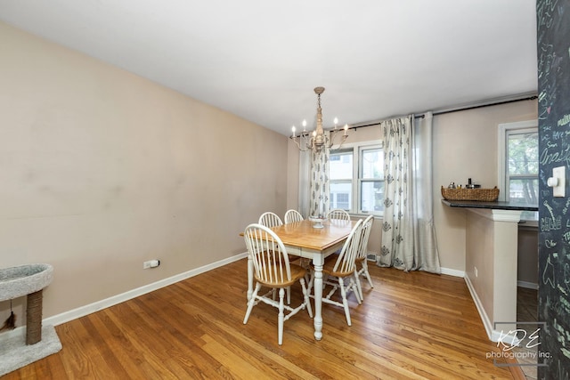 25 Olympus Dr, Naperville, IL 60540 - dining room featuring a chandelier, wood finished floors, and baseboards