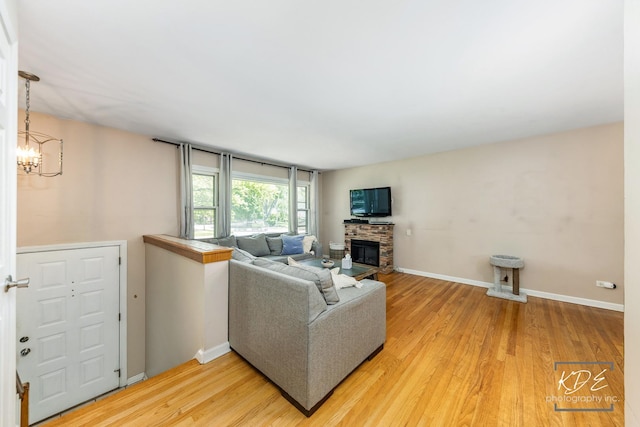 25 Olympus Dr, Naperville, IL 60540 - living room with a chandelier, light wood-style flooring, a fireplace, and baseboards