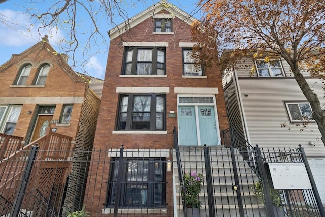 1532 N Greenview Ave, Chicago, IL 60642 - view of front of house with a fenced front yard, brick siding, and a gate