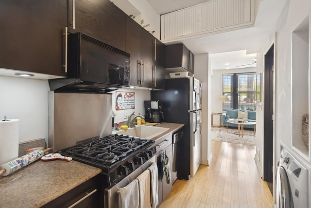 1532 N Greenview Ave, Chicago, IL 60642 - kitchen featuring washer / clothes dryer, black microwave, stainless steel gas range, a sink, and light wood-style floors