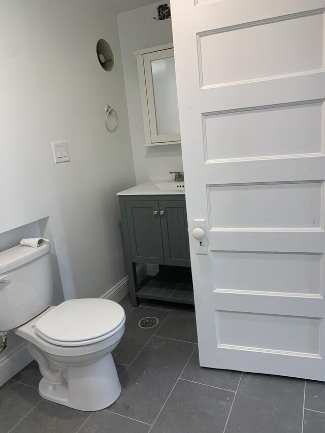 4308 N Whipple St, Chicago, IL 60618 - bathroom with toilet, vanity, tile patterned floors, and baseboards