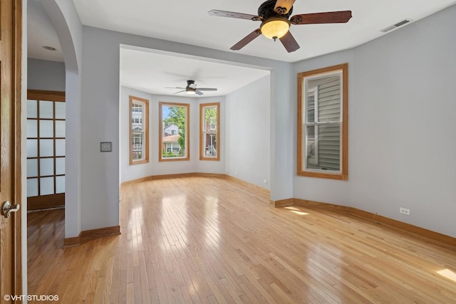 4308 N Whipple St, Chicago, IL 60618 - spare room featuring arched walkways, light wood-style flooring, baseboards, and a ceiling fan