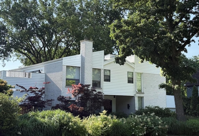 941 Harms Rd, Glenview, IL 60025 - view of side of property with a chimney and brick siding