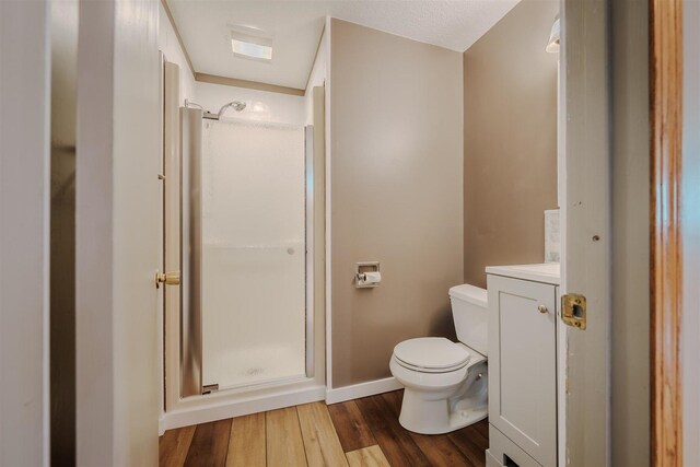20541 E 2050 N Rd, Towanda, IL 61776 - bathroom featuring a stall shower, toilet, wood finished floors, baseboards, and vanity