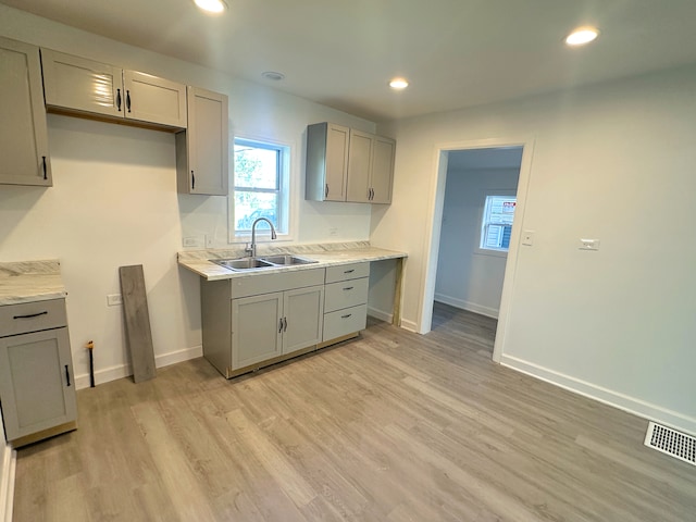 15117 2nd Ave, Phoenix, IL 60426 - kitchen featuring a sink, gray cabinetry, light wood-style flooring, baseboards, and recessed lighting