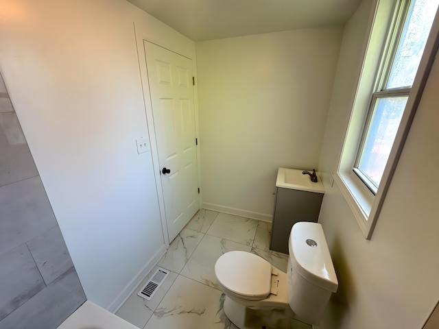 15117 2nd Ave, Phoenix, IL 60426 - bathroom with marble look tiles, toilet, and baseboards