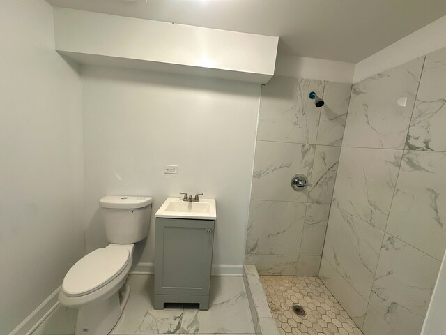 15117 2nd Ave, Phoenix, IL 60426 - full bathroom featuring marble look tile flooring, toilet, a marble finish shower, vanity, and baseboards
