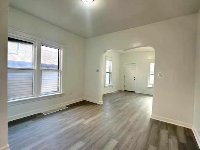 15117 2nd Ave, Phoenix, IL 60426 - spare room with arched walkways, wood finished floors, and baseboards