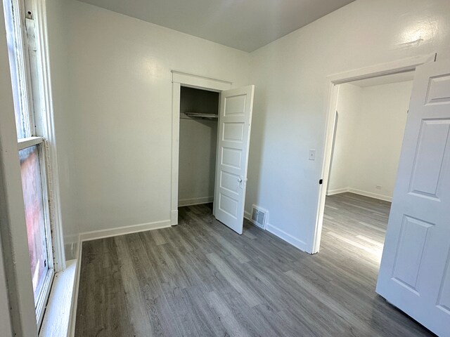15117 2nd Ave, Phoenix, IL 60426 - unfurnished bedroom featuring wood finished floors, baseboards, and a closet
