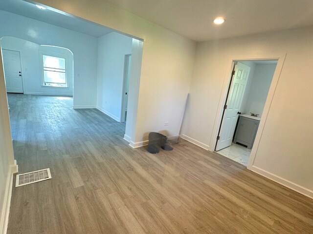 15117 2nd Ave, Phoenix, IL 60426 - unfurnished room with arched walkways, light wood-type flooring, baseboards, and recessed lighting