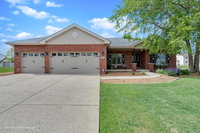 608 W N St, Peotone, IL 60468 - ranch-style home featuring a garage, a front yard, driveway, brick siding, and covered porch