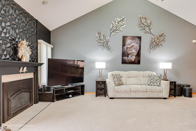608 W N St, Peotone, IL 60468 - carpeted living area featuring baseboards, a tiled fireplace, and high vaulted ceiling
