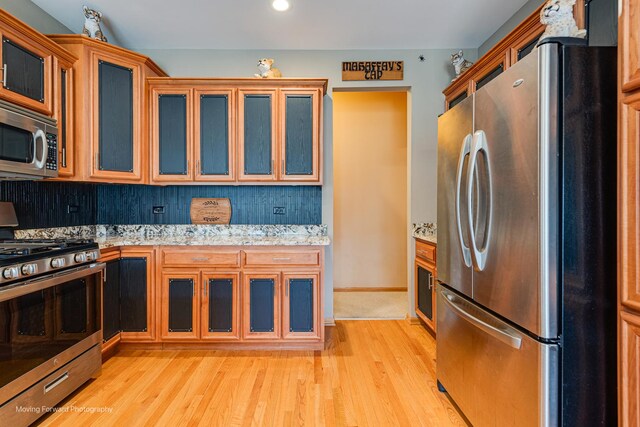 608 W N St, Peotone, IL 60468 - kitchen featuring stainless steel appliances, light wood-style floors, tasteful backsplash, glass insert cabinets, and recessed lighting