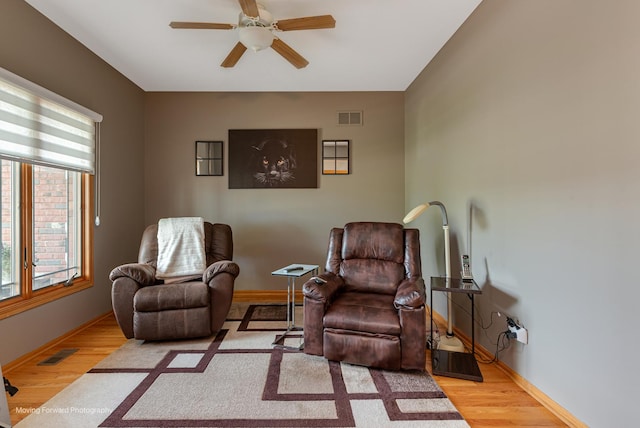 608 W N St, Peotone, IL 60468 - living area with healthy amount of natural light, ceiling fan, wood finished floors, and baseboards