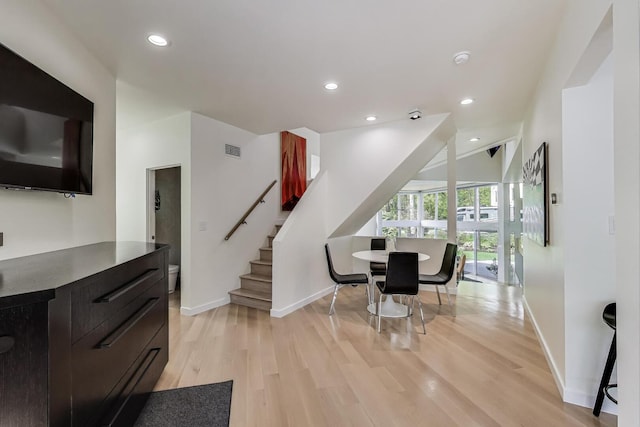 870 Woodbine Rd, Highland Park, IL 60035 - dining room featuring baseboards, stairs, light wood-style floors, recessed lighting, and vaulted ceiling
