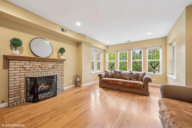 7315 N Honore St Unit 1, Chicago, IL 60626 - living area with wood-type flooring, baseboards, a brick fireplace, and recessed lighting
