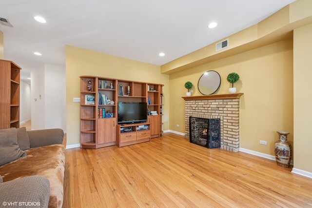 7315 N Honore St Unit 1, Chicago, IL 60626 - living room with light wood finished floors, a fireplace, baseboards, and recessed lighting