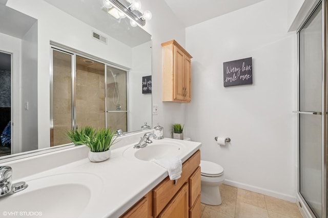 7315 N Honore St Unit 1, Chicago, IL 60626 - bathroom with toilet, a shower with door, double vanity, baseboards, and tile patterned floors