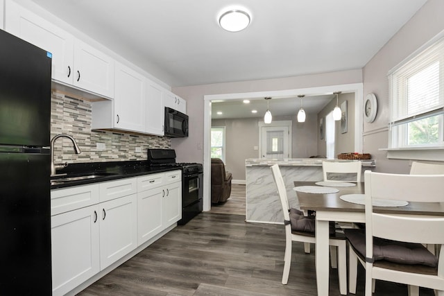 3737 Rose Manor Ter, Markham, IL 60428 - kitchen with black appliances, a sink, white cabinets, and decorative backsplash