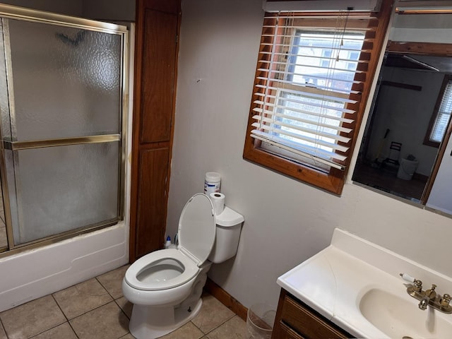 2177 N Merrimac Ave, Chicago, IL 60639 - bathroom featuring vanity, tile patterned flooring, toilet, combined bath / shower with glass door, and baseboards
