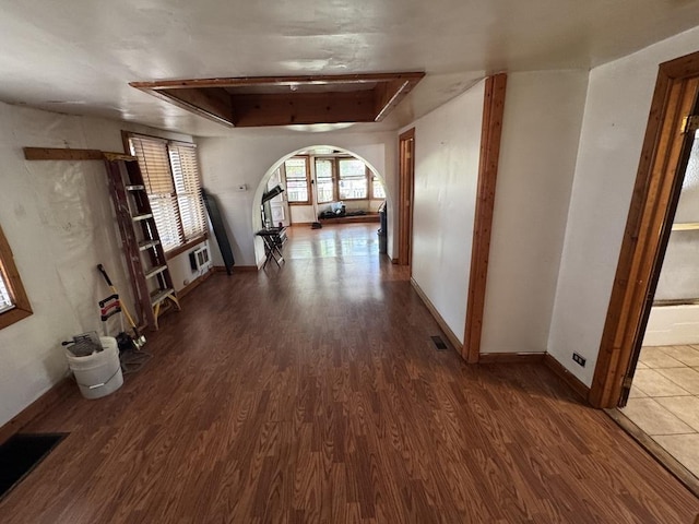 2177 N Merrimac Ave, Chicago, IL 60639 - hallway featuring wood finished floors, arched walkways, baseboards, and a raised ceiling