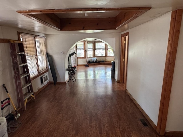 2177 N Merrimac Ave, Chicago, IL 60639 - unfurnished living room with arched walkways, wood finished floors, baseboards, and a raised ceiling