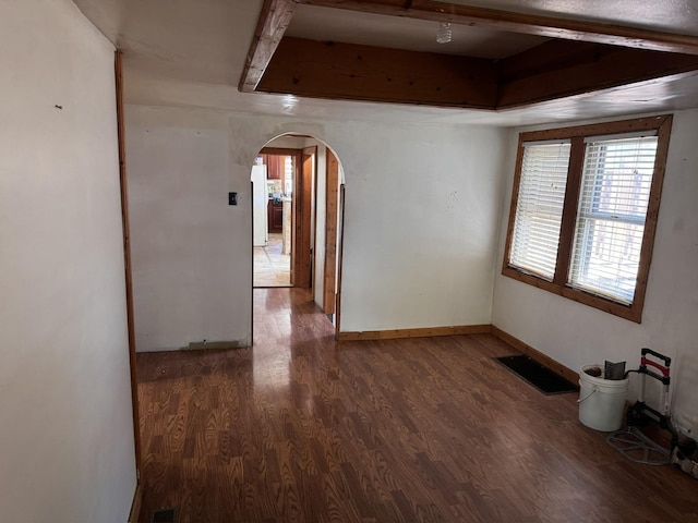 2177 N Merrimac Ave, Chicago, IL 60639 - empty room featuring arched walkways, wood finished floors, and baseboards