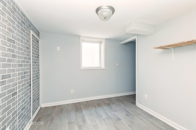 1826 Ohio Pkwy, Rockford, IL 61108 - unfurnished bedroom featuring wood finished floors and brick wall