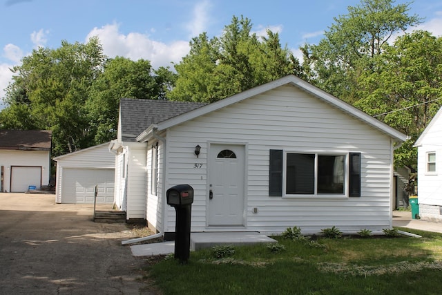 517 Victor St, Sycamore, IL 60178 - view of front of home with an outdoor structure, a shingled roof, and a garage