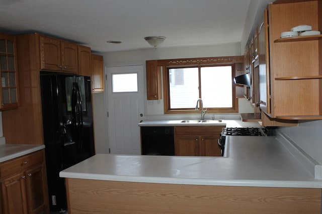 517 Victor St, Sycamore, IL 60178 - kitchen featuring black appliances, a sink, brown cabinetry, a peninsula, and light countertops