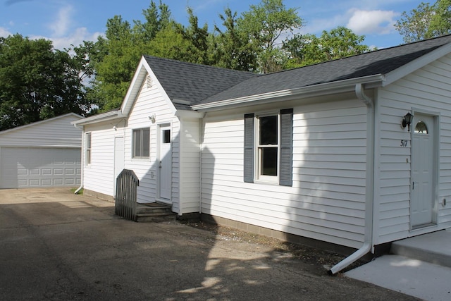 517 Victor St, Sycamore, IL 60178 - view of front of home with an outdoor structure, a shingled roof, and a garage