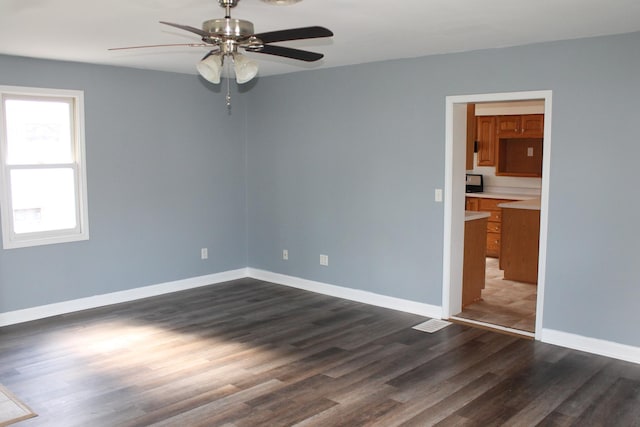 517 Victor St, Sycamore, IL 60178 - unfurnished room featuring a ceiling fan, dark wood finished floors, and baseboards