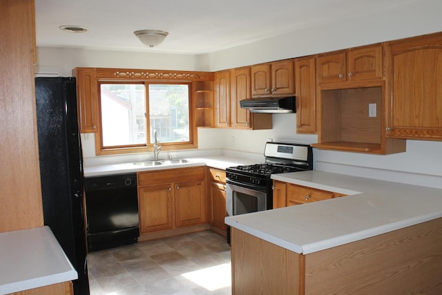 517 Victor St, Sycamore, IL 60178 - kitchen with black appliances, a sink, under cabinet range hood, a peninsula, and light countertops