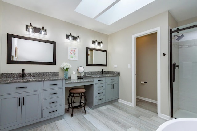 215 Hilltop Ln, Sleepy Hollow, IL 60118 - bathroom with a stall shower, a skylight, vanity, and wood finished floors