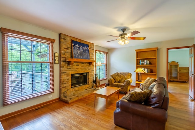 215 Hilltop Ln, Sleepy Hollow, IL 60118 - living room featuring light wood-style flooring, a ceiling fan, a fireplace, and baseboards