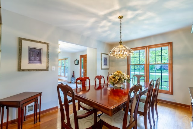 215 Hilltop Ln, Sleepy Hollow, IL 60118 - dining area with a chandelier, light wood-style floors, and baseboards