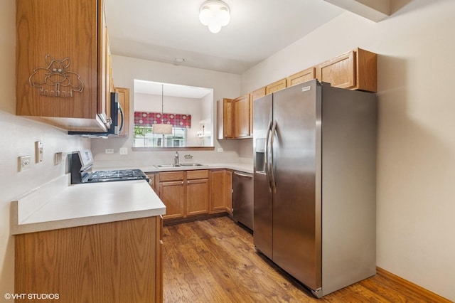 2258 Reflections Dr Unit 2258, Aurora, IL 60502 - kitchen with stainless steel appliances, light countertops, wood finished floors, a sink, and brown cabinets