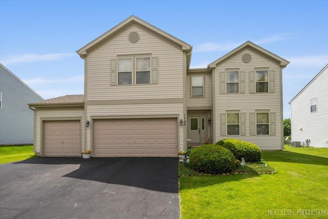 1705 Heatherstone Ave, Montgomery, IL 60538 - view of front of home featuring asphalt driveway, a front lawn, cooling unit, and a garage