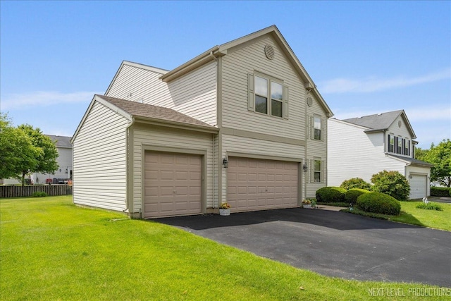 1705 Heatherstone Ave, Montgomery, IL 60538 - view of front of property with a front yard, asphalt driveway, and an attached garage