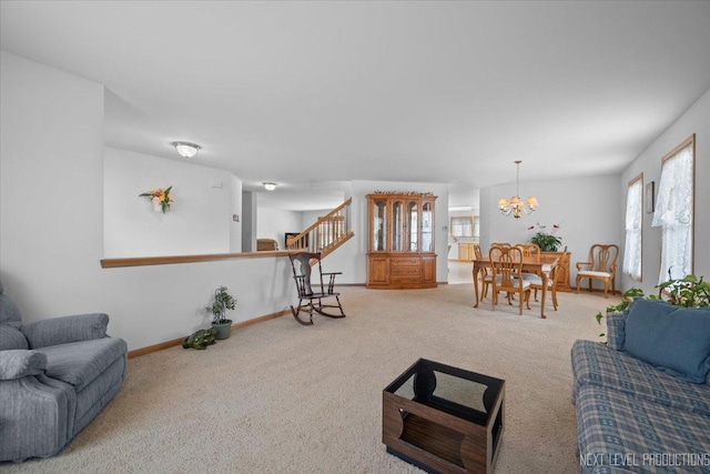 1705 Heatherstone Ave, Montgomery, IL 60538 - carpeted living area featuring stairway, a chandelier, and baseboards