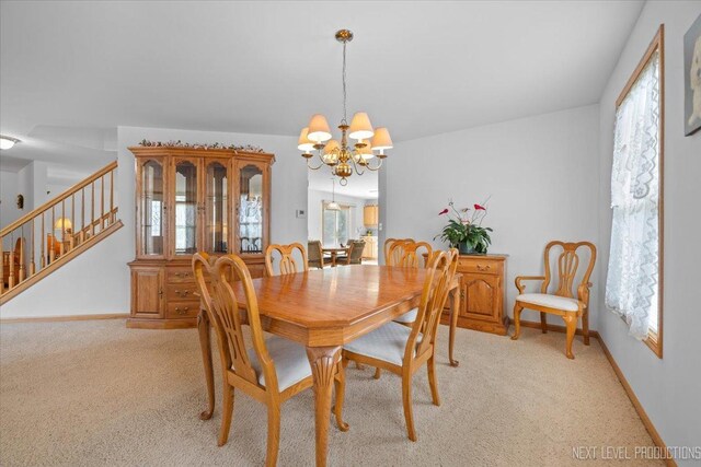 1705 Heatherstone Ave, Montgomery, IL 60538 - dining area with a chandelier, stairs, light carpet, and healthy amount of natural light